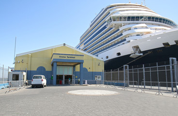 Cruise Ship Terminal at Gibraltar Port, United Kingdom.  Unidentifiable Cruise tied up at dock.  Cruise Terminal Sign has been altered to Generic Markings.