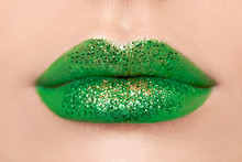 Conceptual Photo Of St. Patrick's Day. Close Up View Of Woman Lips With Green Lipstick. Holiday Makeup