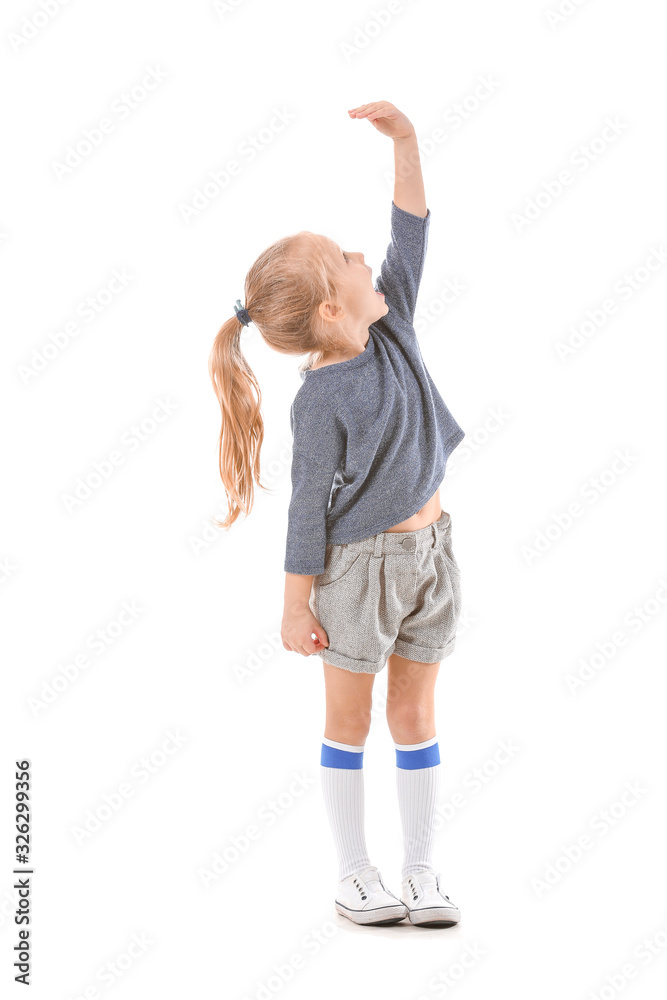 Cute little girl measuring height on white background