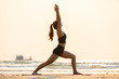 © 220 Selfmade studio - Vacation of Attractive Asian woman relaxing in yoga Warrior one pose on the sand and beach with sunset beautiful sea in Tropical island,Feeling comfortable and relax in holiday,Vacations Concept