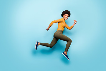 Wall Mural - Full length body size profile side view of nice sporty cheerful strong active purposeful wavy-haired girl running isolated on bright vivid shine vibrant blue green teal turquoise color background