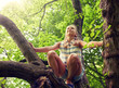 © Syda Productions - friendship, childhood, leisure and people concept - happy girl climbing up tree and having fun in summer park