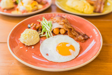 Canvas Print - Fried egg with bacaon sausage ham vegetable potato in plate