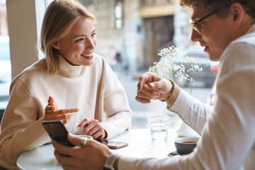 Poster - Attractive young lovely couple having coffee at the cafe