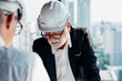 © Shutter B - Two industrial engineer wear safety helmet engineering working and talking with drawings inspection modern city background. Industry, Engineering, construction concept. With copy space for your text.