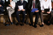 © New Africa - People waiting for job interview in office hall, closeup