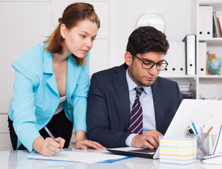 Businessman and businesswoman working together