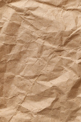Wall Mural - A vertically oriented piece of crumpled used wrapping paper with rough folds and bends. Abstract modern trendy paper texture background
