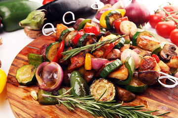 Wall Mural - Grilled pork shish or kebab on skewers with vegetables . Food background shashlik