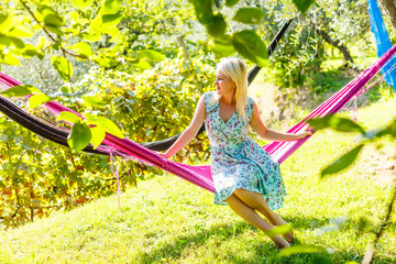 Happy Young Woman relaxing in hammock