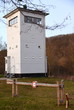 Wachturm an der innerdeutschen Grenze mit Schlagbaum im Vordergrund