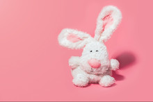Adorable Stuffed Bunny On Pink Background With Copy Space. Minimal Easter Concept.