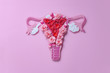 Leinwandbild Motiv The women's reproductive system. The concept of women's health. Paper flowers