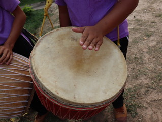 Human hand play music on  drums outdoors.