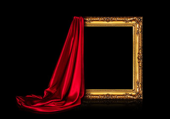 Wall Mural - The wooden frame for the picture is covered with a silk red cloth isolated on a black background. Antique golden frame.