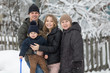 © Make_story Studio - Winter portrait on a forest background. .Happy portrait of a family.