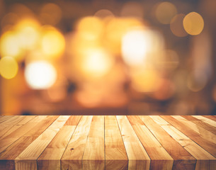 Wall Mural - Wood texture table top (counter bar) with blur light gold bokeh background