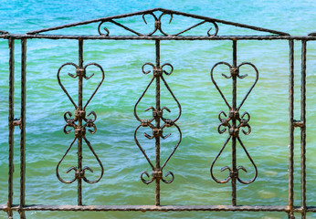 Art work old iron, gate, frame, decorative wrought fence retro decor architecture, element, ornament.