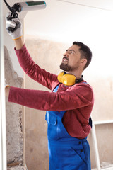 Canvas Print - Worker using foam gun for window installation indoors