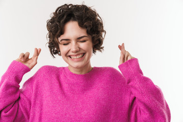 Poster - Image of cheerful young woman holding fingers crossed and smiling