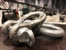 Steel Rigging Shackles On Flight Case. Metal Truss With Light And Sound Equipment.