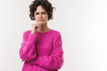 Wall Mural - Image of displeased brunette woman posing and looking at camera