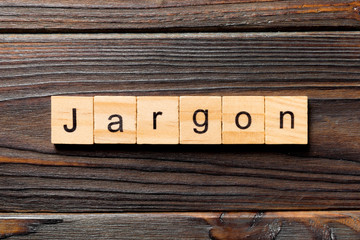 Jargon word written on wood block. Jargon text on wooden table for your desing, Top view concept