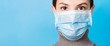 Leinwandbild Motiv Portrait of young woman wearing medical mask at blue background. Protect your health. Coronavirus concept