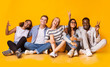 © Prostock-studio - Carefree teenagers having fun over yellow studio background