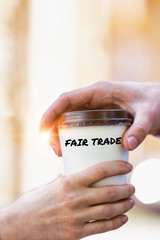 Wall Mural - Close up photo of businesswoman giving businessman a cup of fair trade coffee