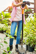 © MDBPIXS - Portrait of gardener leaning on shovel in shop