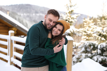 Sticker - Lovely couple spending time together on snowy day. Winter vacation