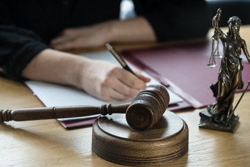 Canvas Print - justice and law concept. Female judge in a courtroom on wooden table and Counselor or Male lawyer working in office. Legal law, advice and justice concept.