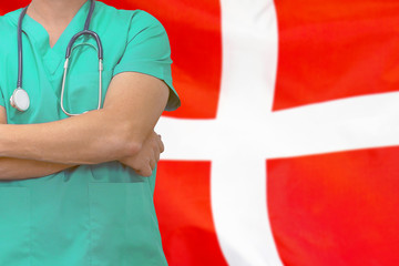 Male surgeon or doctor with stethoscope on the background of the Denmark flag. Health care and medical concept. Surgery concept in Denmark.