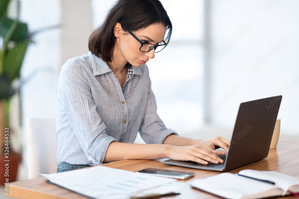 Woman using personal computer at her home Stock Photo | Adobe Stock