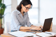 © Prostock-studio - Woman using personal computer at her home