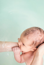 Mother Bathing Newborn Baby