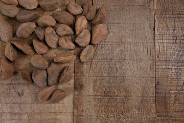 Wall Mural - Bowl with Brazil nuts on wooden table. Space for text