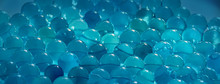 Blue Abstract Background. Round Glass Alike Pearls Laying Together.