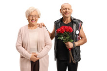 Punk Guy With A Bunch Of Red Roses Posing With An Elderly Woman