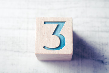 Poster - Number 3 On A Wooden Block On A Table