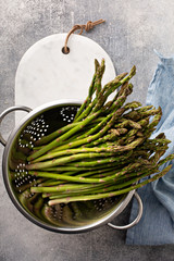 Canvas Print - Cooking with asparagus, just washed fresh asparagus in a colander