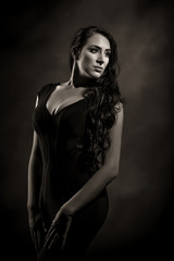 Brunet Girl in Black Dress Dark Background