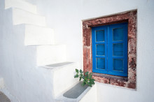 Quaint Mediterranean Blue Window With Greek Whitewashed Steps On The Exterior