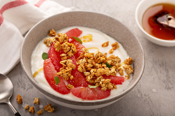 Wall Mural - Yougurt bowl with grapefruit slices, honey and granola