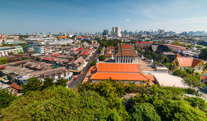 Wall Mural - Traditional Thai Architecture with Modern Buildings and Skyscrapers in Background. Cityscape of Bangkok, Thailand as Seen from Temple of the Golden Mount (Wat Saket).