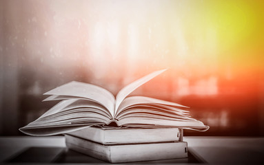 Poster - the concept of education by planting a tree of knowledge in the opening of an old book in the librar