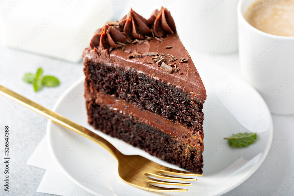 Dark chocolate cake slice with chocolate buttercream frosting Stock ...