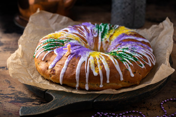 King cake for Mardi Gras, New Orlean traditional pastry with a plastic baby