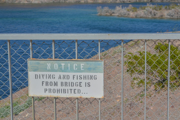 Wall Mural - Diving and Fishing From Bridge is Prohibited Sign at the Arizona Nevada border on Lake Mohave, Mohave County, Arizona USA